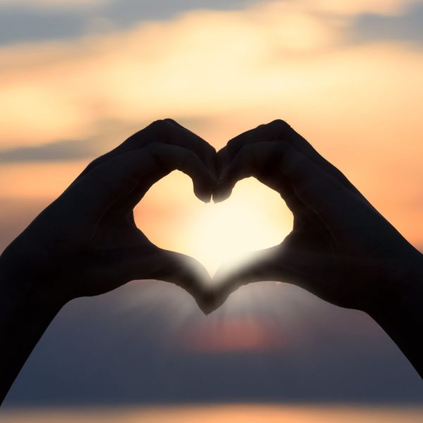 hand in heart sunset